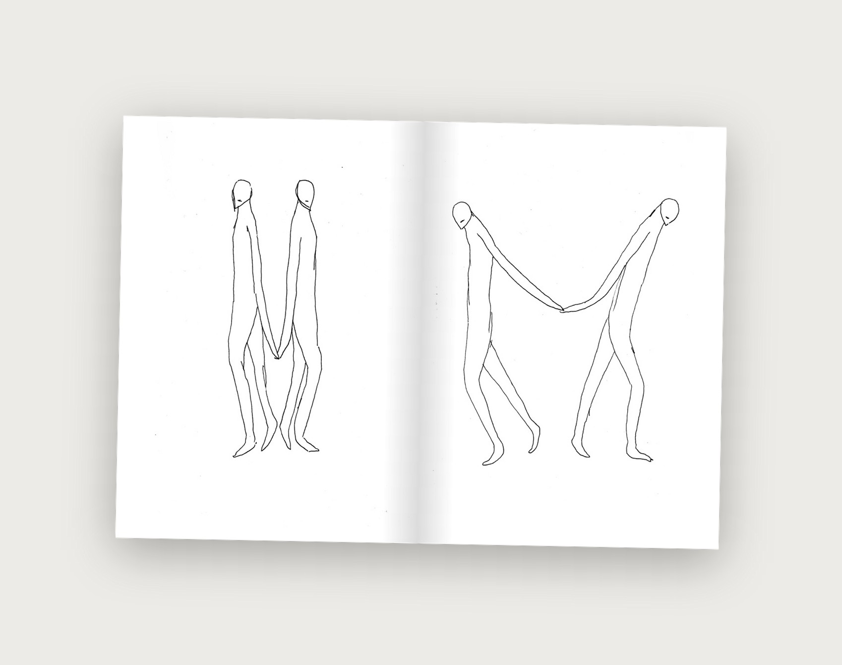 Dichotomy zine spread showing two figures walking apart, still holding hands